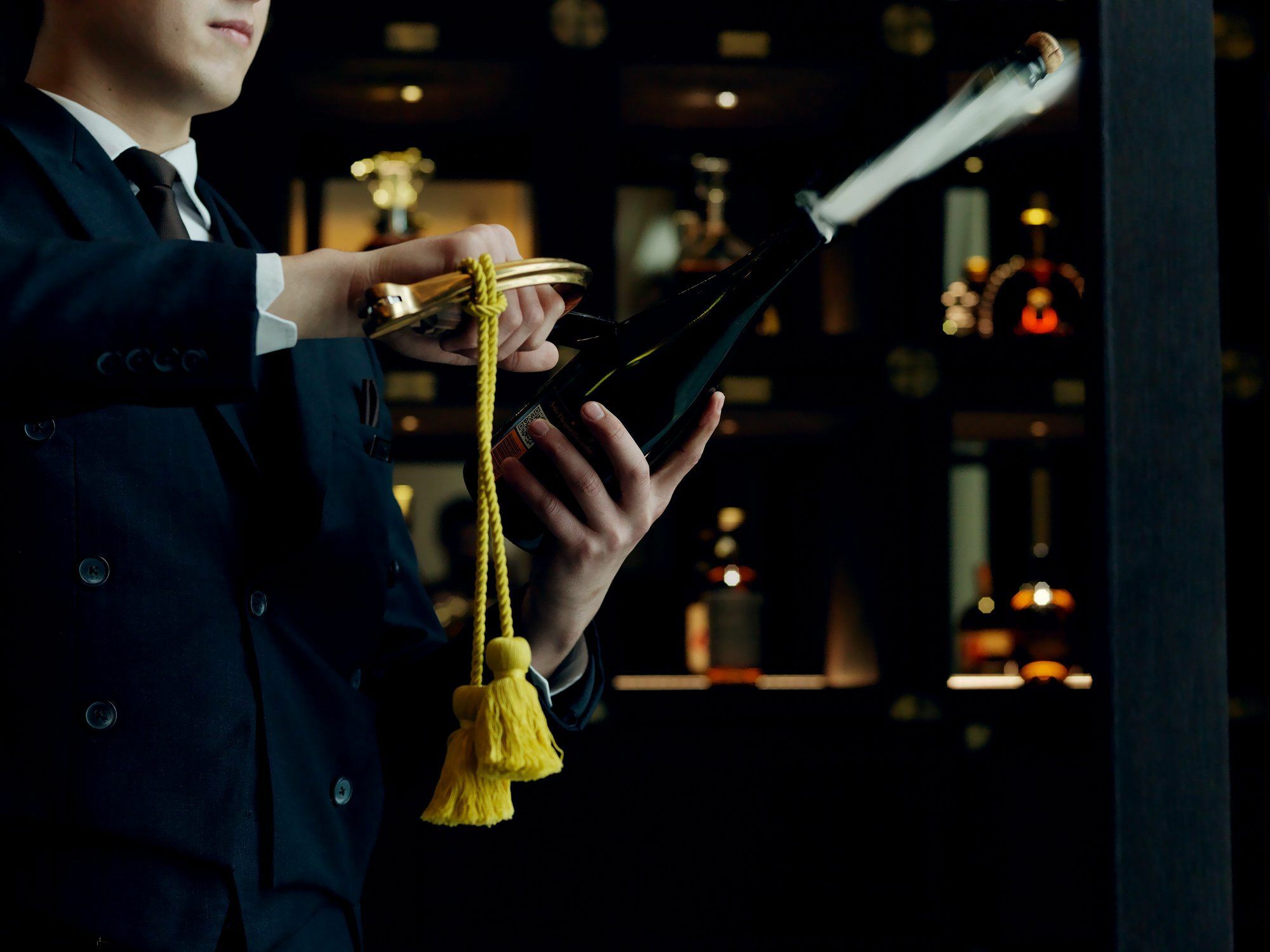 The St. Regis Astana Exterior foto A wine waiter opening a bottle of wine